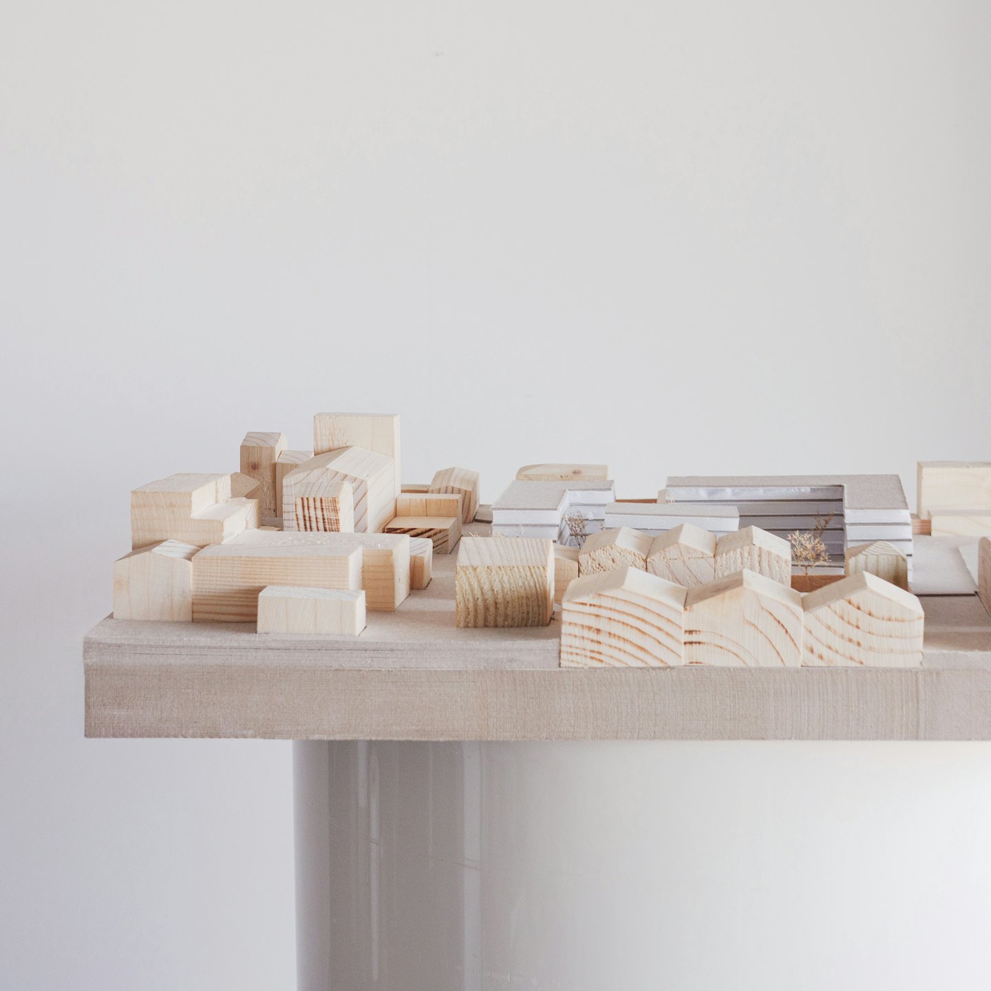 Wooden architectural model of a city with buildings.